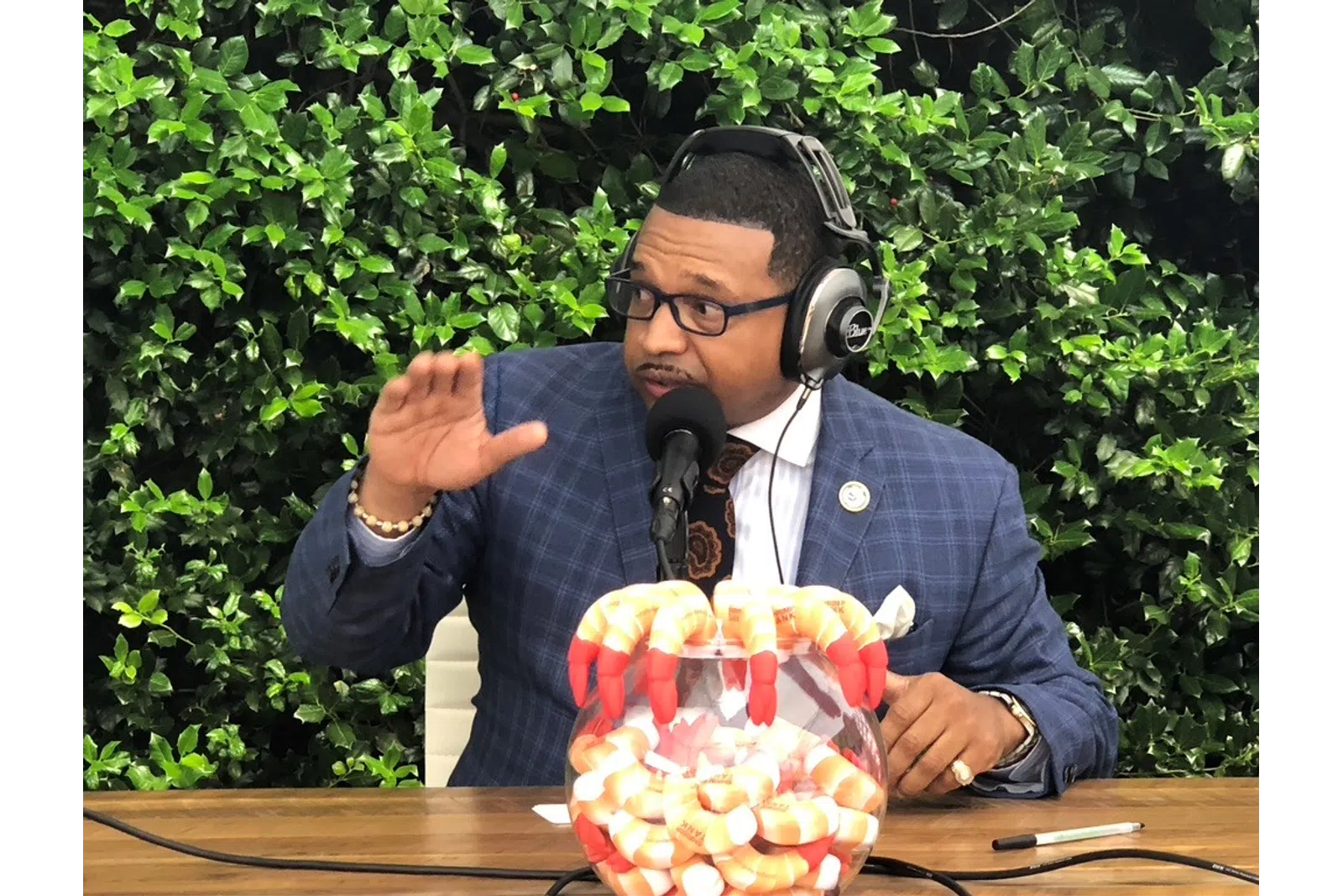 Rashad Richey wearing headphones and sitting at a table with a bowl of food