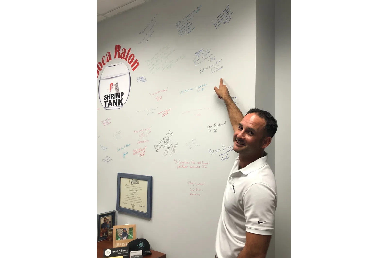 a man leaning on a white board