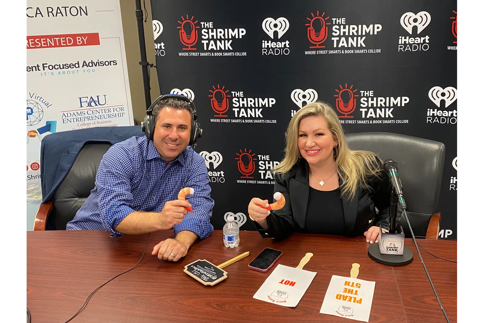 Emily Pantelides et al. sitting at a table with a microphone