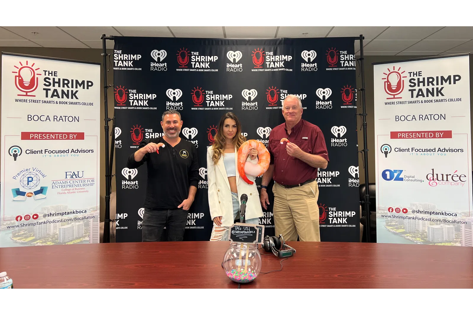 a group of people standing in front of a table with a trophy