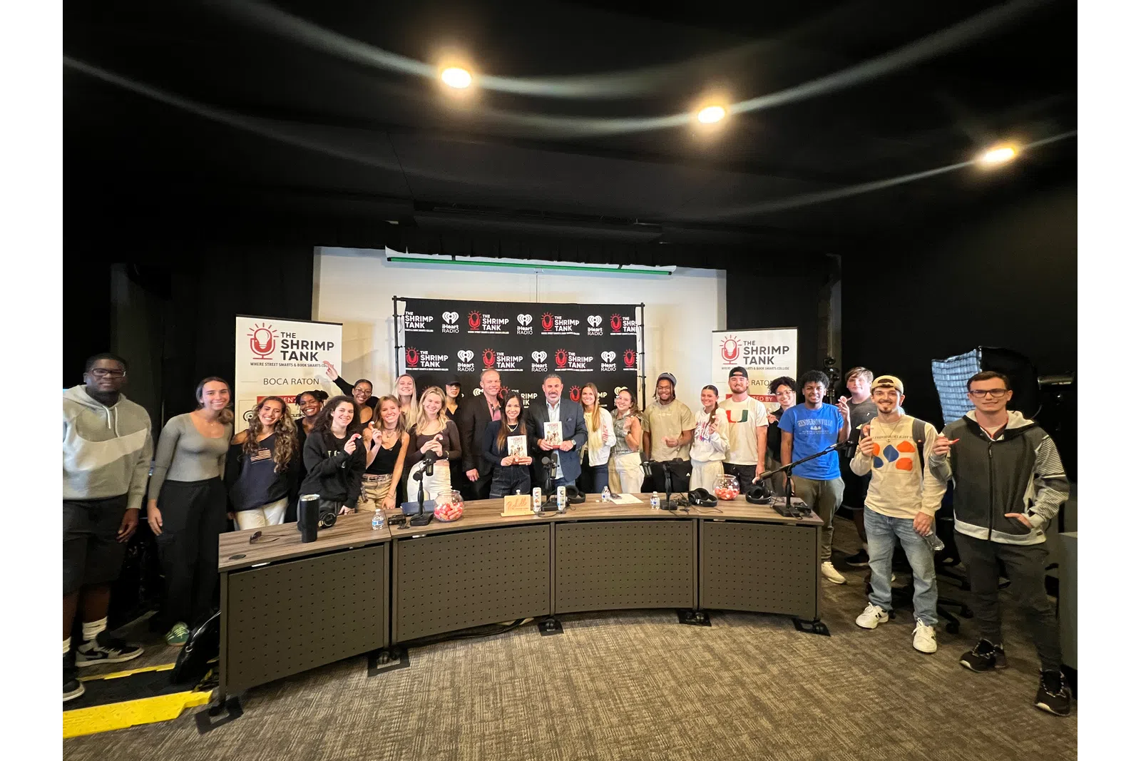a group of people standing in front of a sign