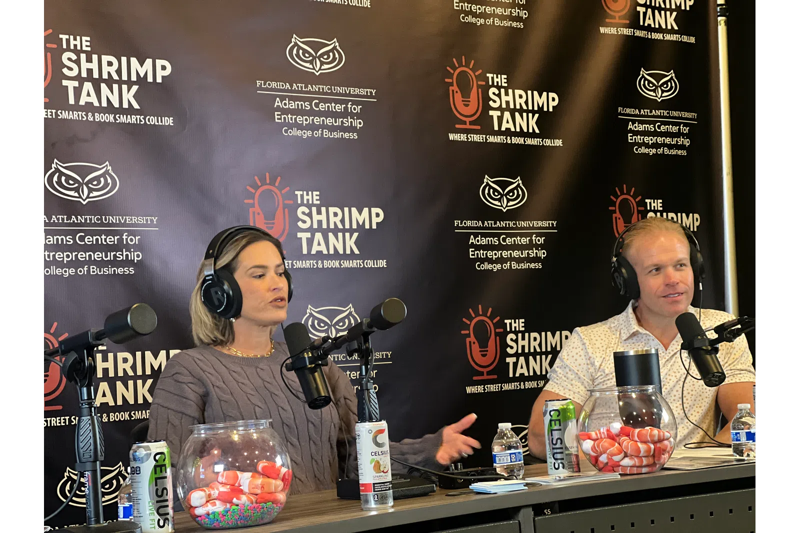 women sitting at a table with microphones and drinks