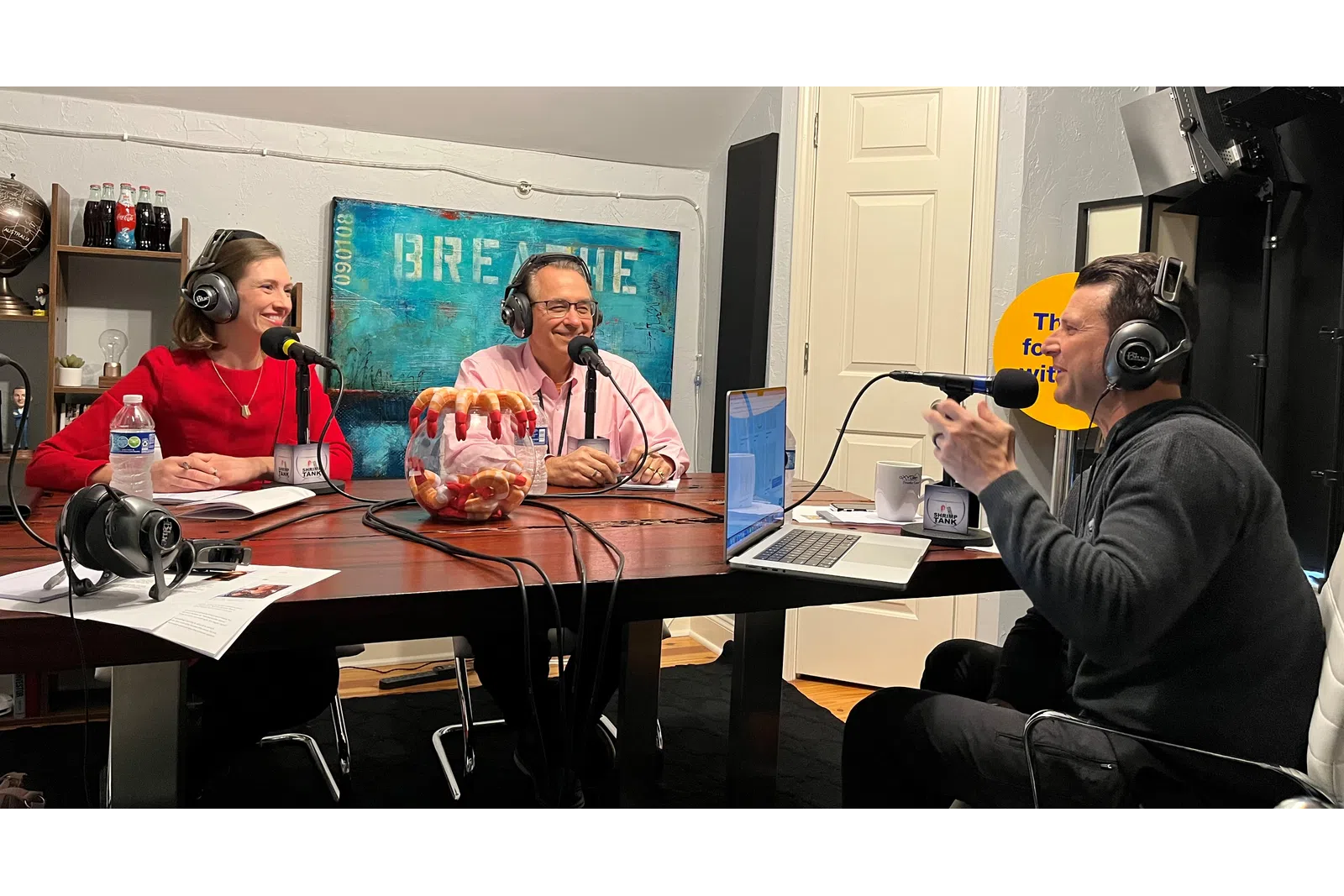 a group of people sitting at a table with microphones