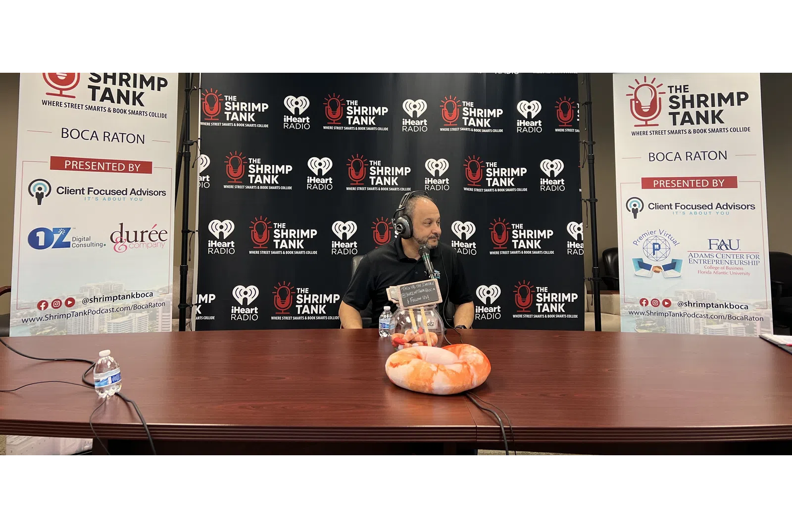 a person sitting at a table with a microphone and a bread on it