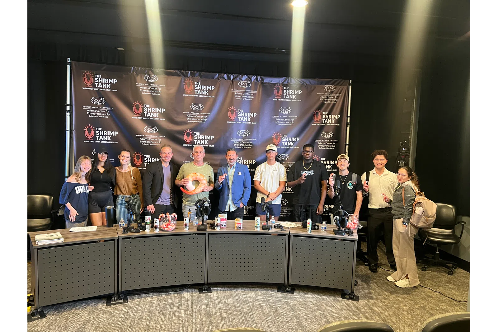 a group of people standing in front of a large screen