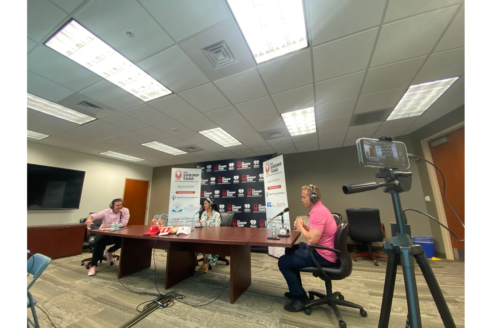 a group of people sitting at a table in a room with a projector and a projector