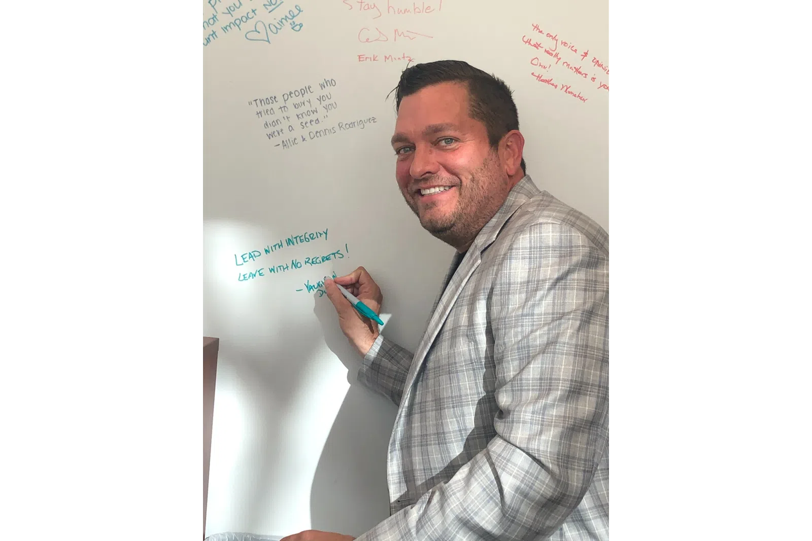 a man writing on a whiteboard