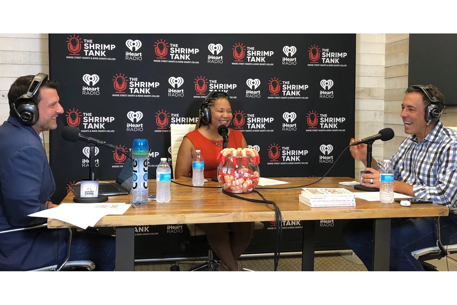 a group of people sitting at a table with microphones
