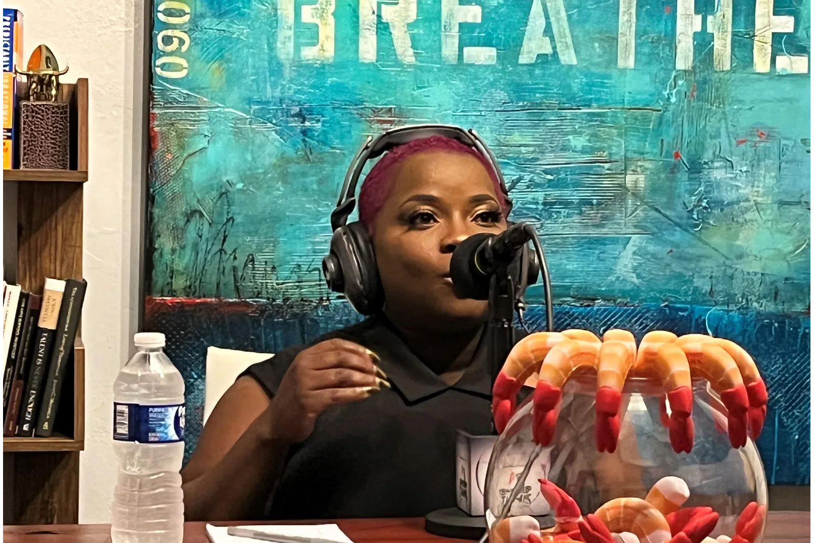 a girl wearing headphones and sitting at a table with food