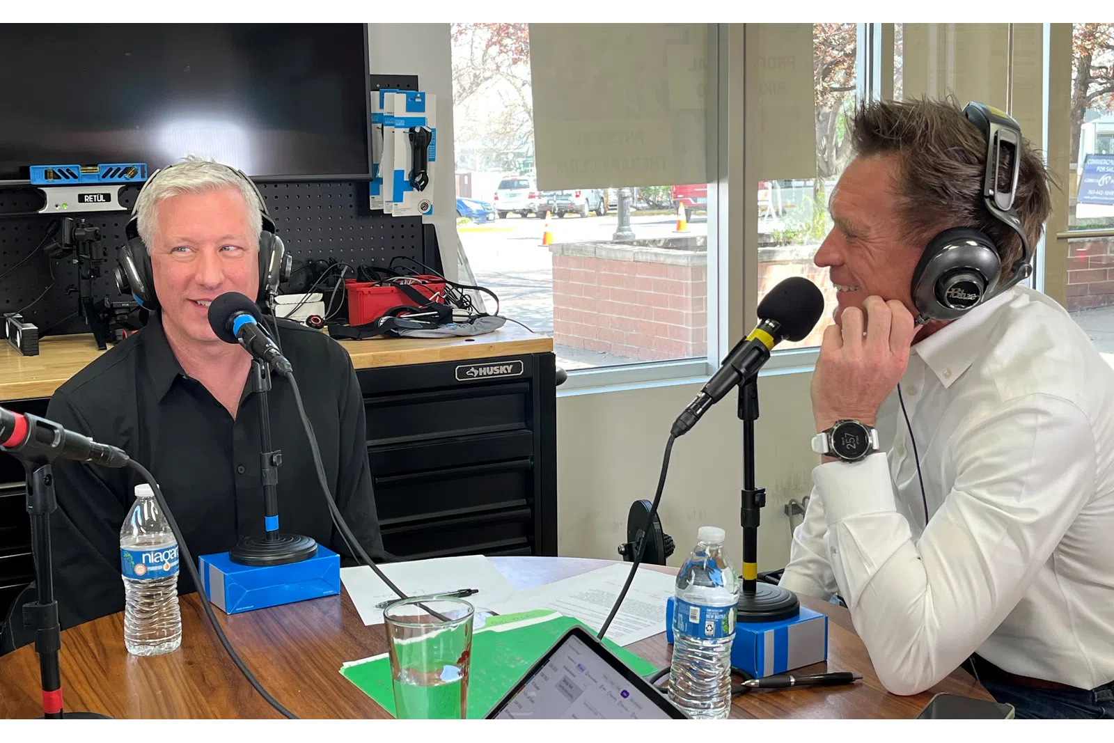 Ken Dunek wearing headphones and sitting at a table with a microphone