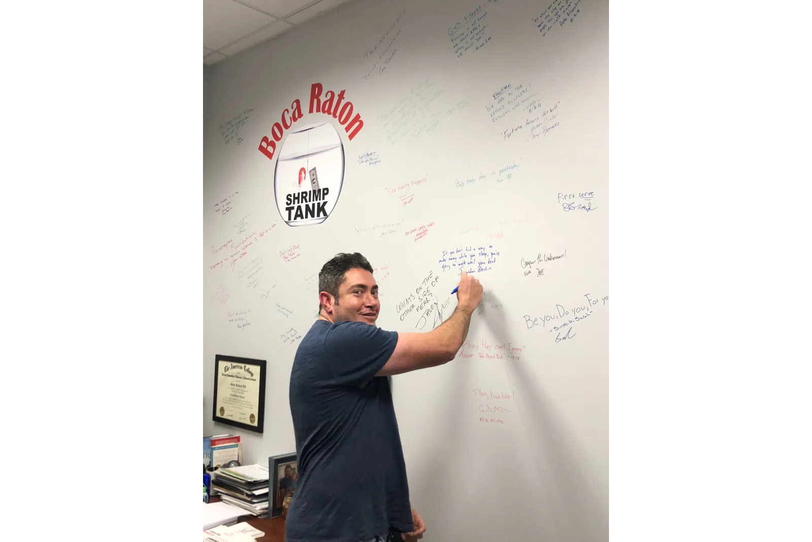 a man standing in front of a whiteboard