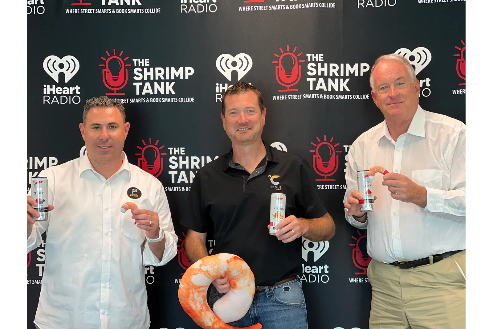 a group of men holding drinks and a donut
