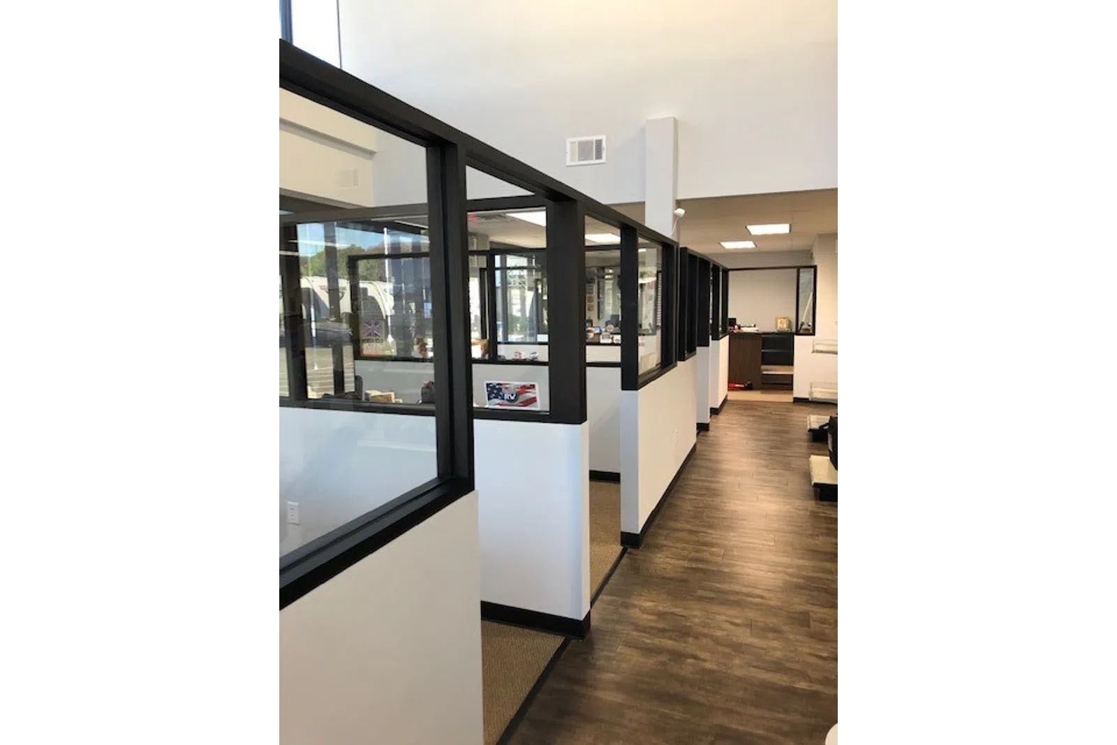 a room with a glass wall and a wood floor