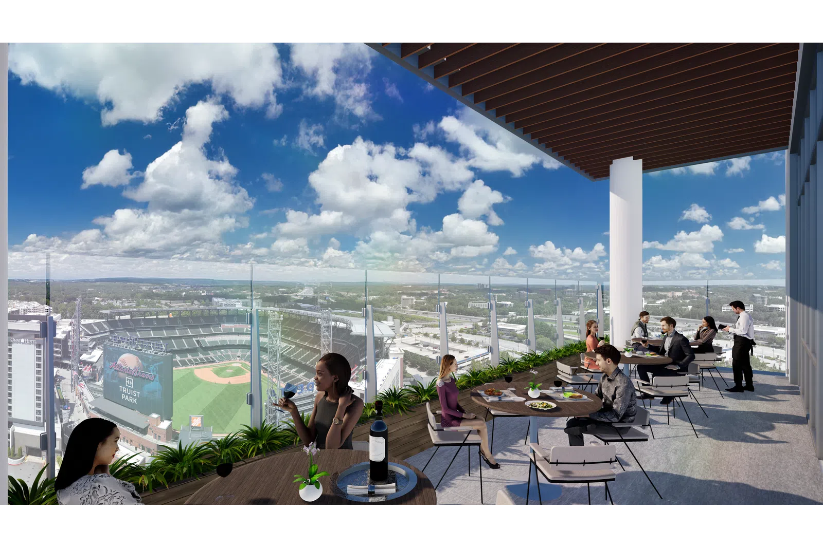 People dining on a rooftop terrace overlooking a baseball stadium and city under a blue sky with clouds.