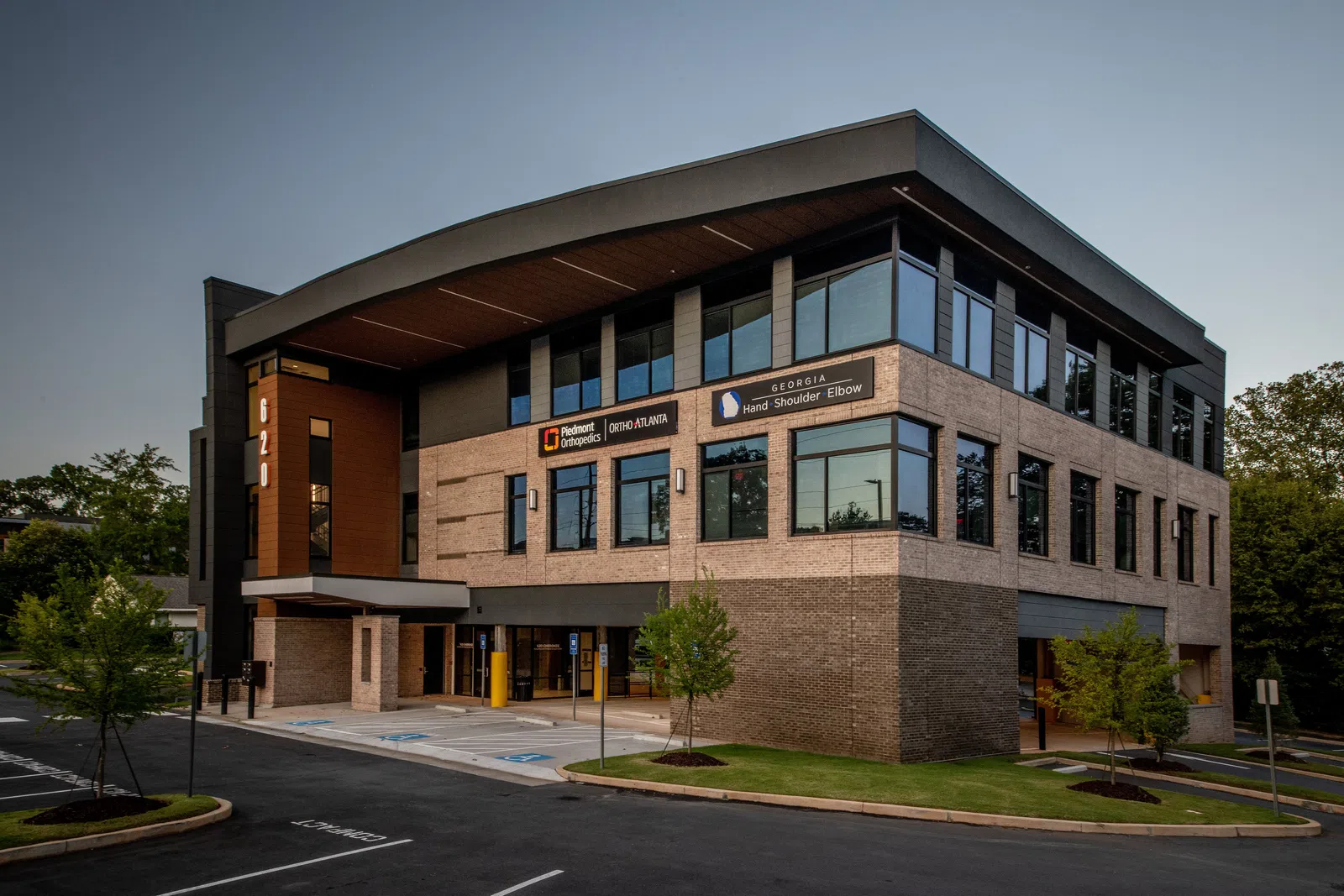 Modern three-story medical office building with signage for Piedmont Orthopedics and Georgia Hand Shoulder Elbow Clinic.