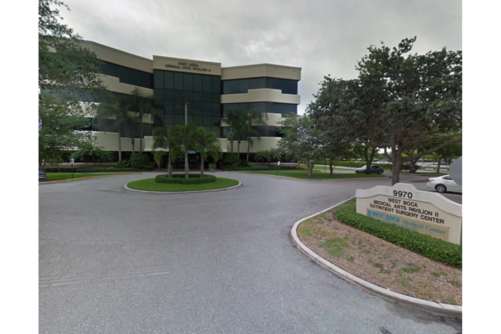 West Boca Medical Arts Pavilion II outpatient surgery center building with signage and surrounding trees.