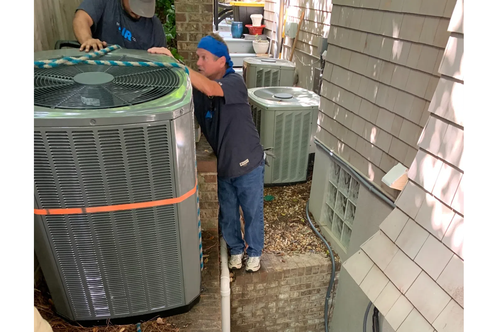 a man standing next to a grill