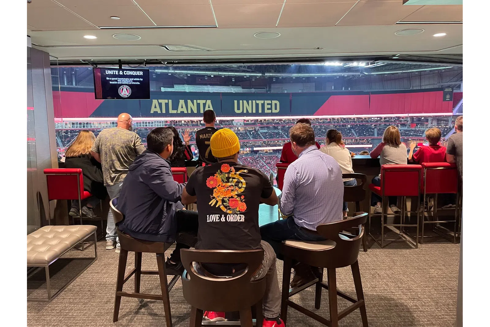 a group of people sitting at a table in a restaurant