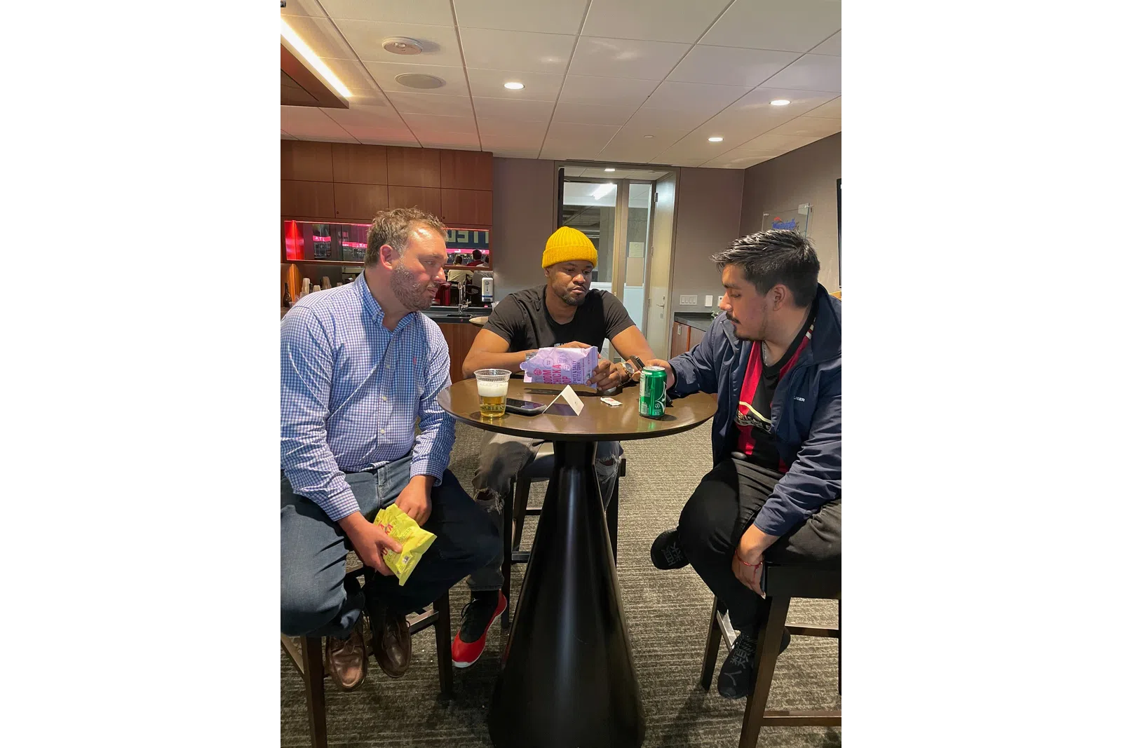 a group of people standing around a table