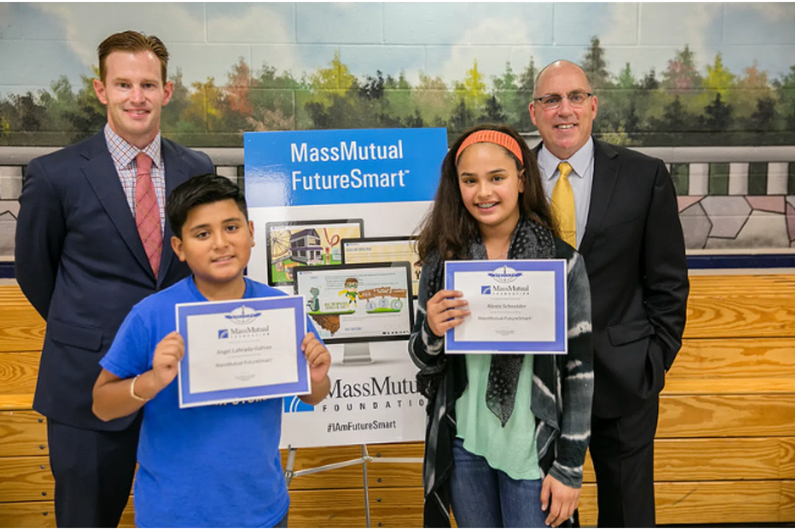 a group of people holding certificates