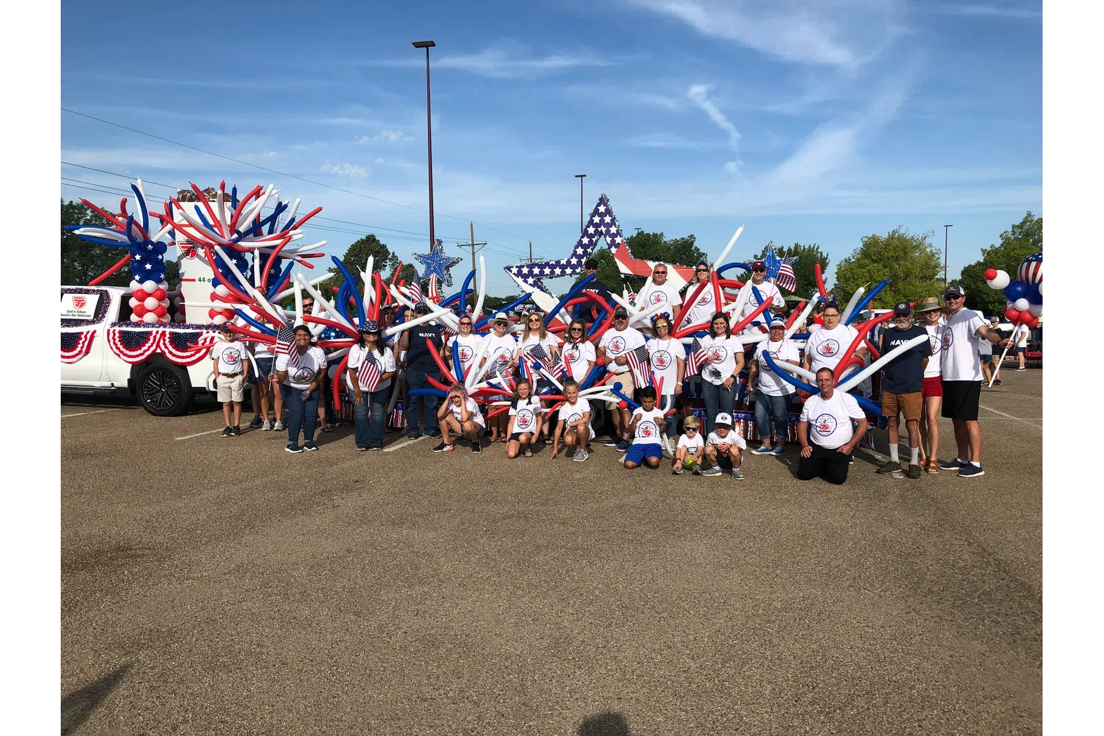 a group of people holding flags with Cadillac Ranch in the background