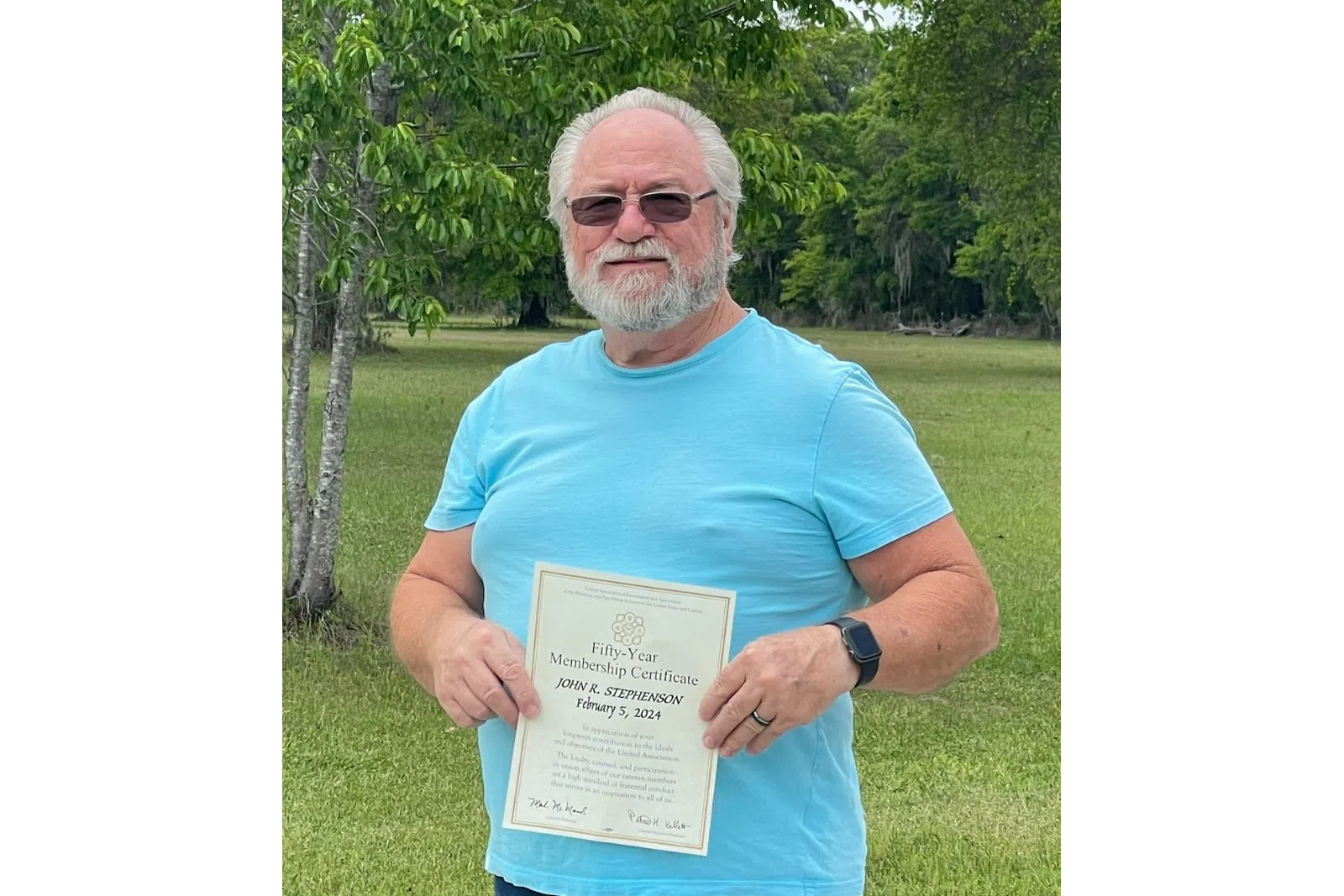 Ken Bates holding a certificate