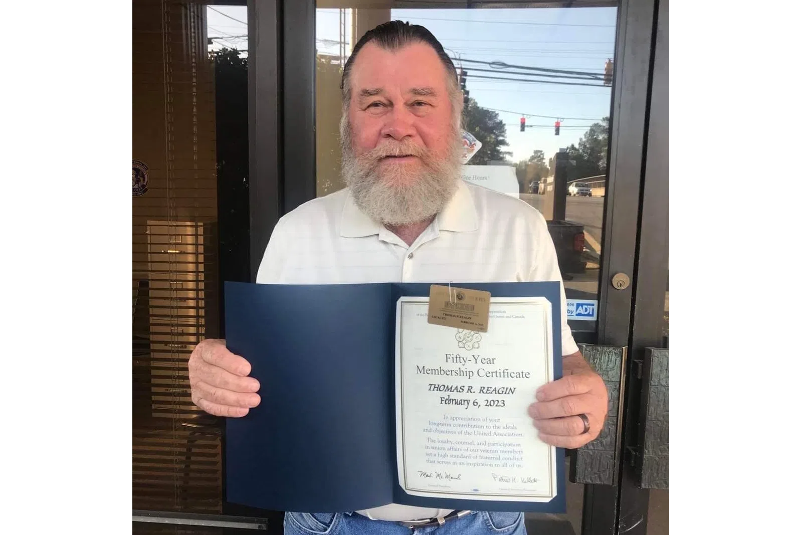 a man holding a certificate