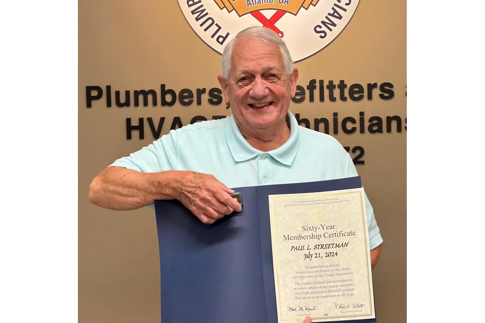 a man holding a certificate