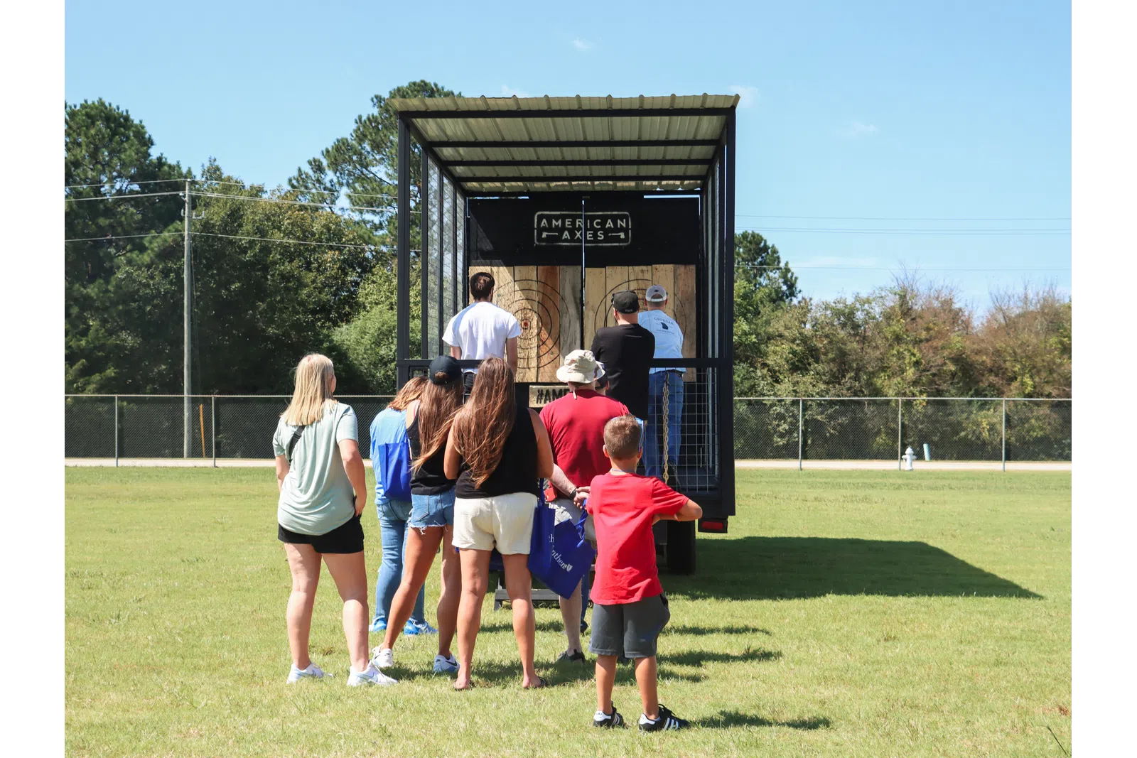 a group of people standing in front of a sign