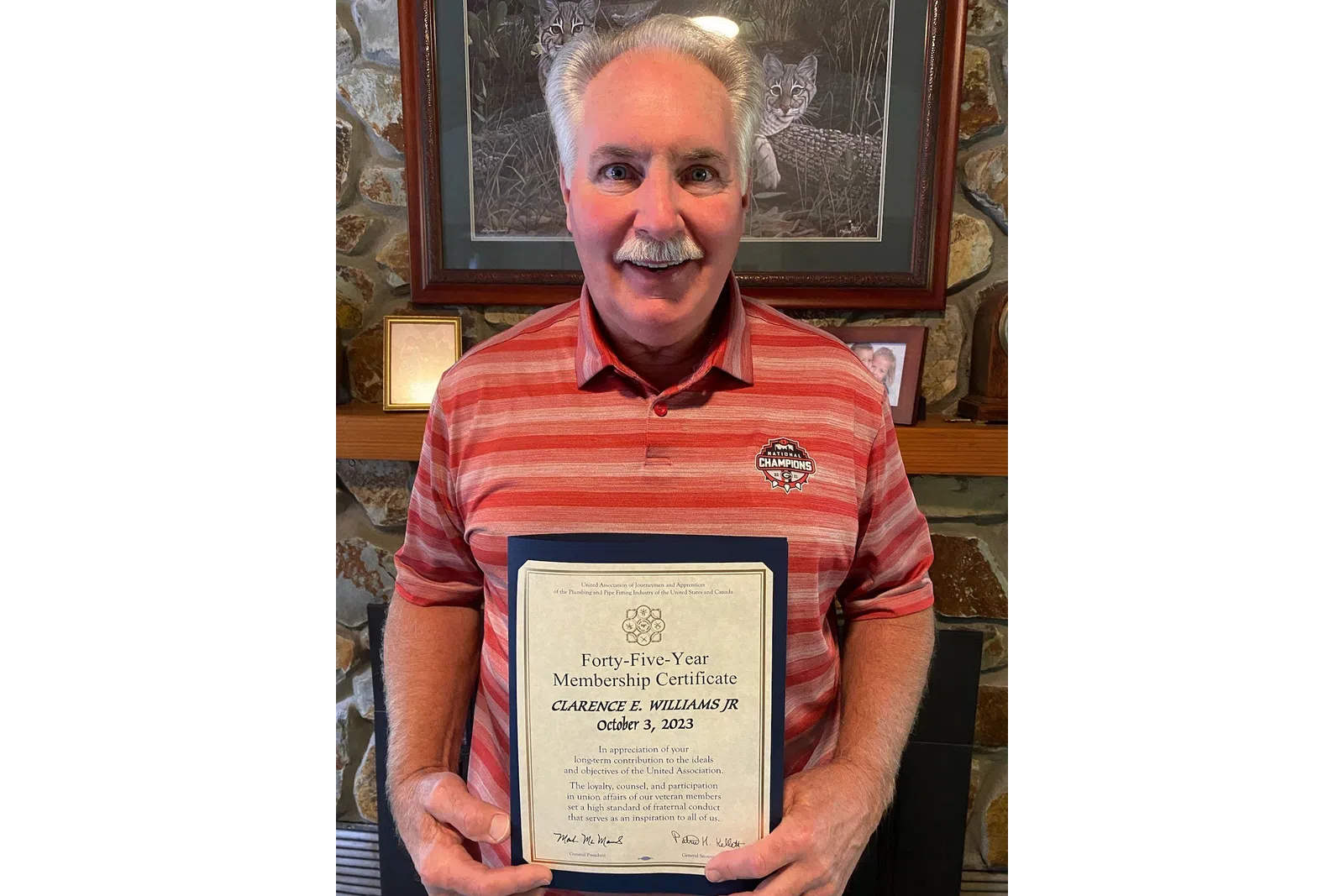 a man holding a certificate