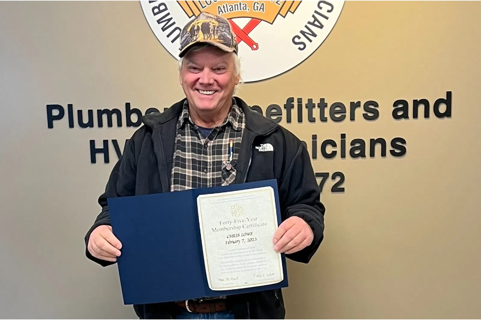 a man holding a certificate
