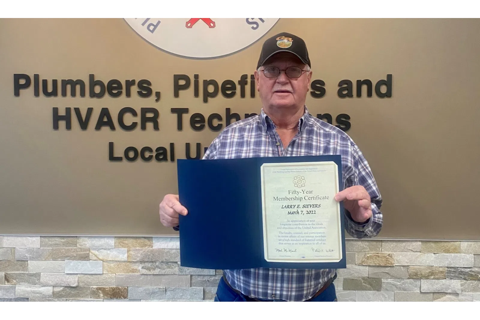 a man holding a plaque