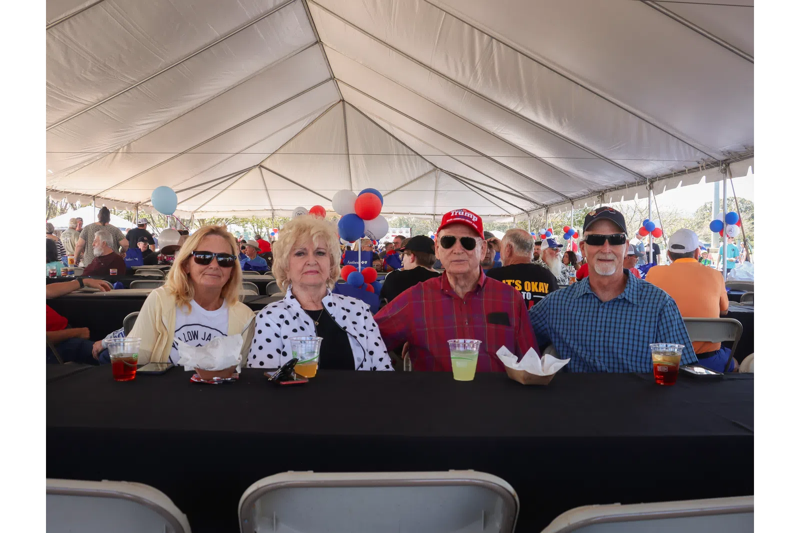 a group of people sitting at a table with drinks