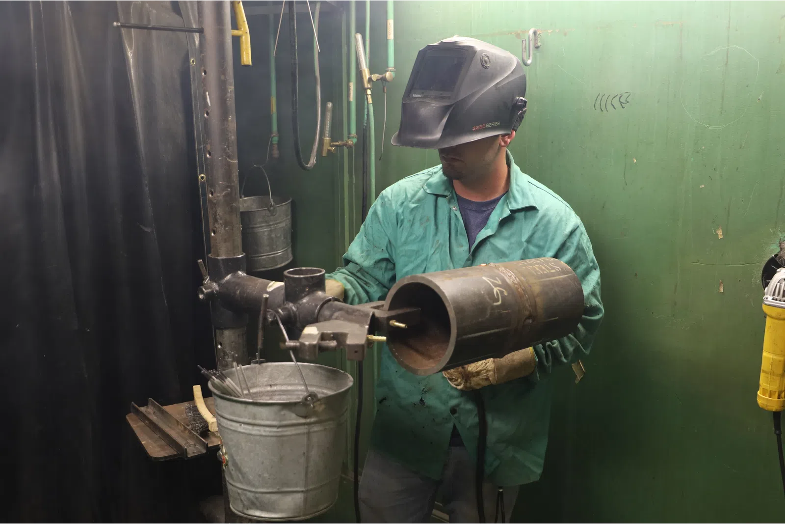 a man wearing a helmet and holding a pipe