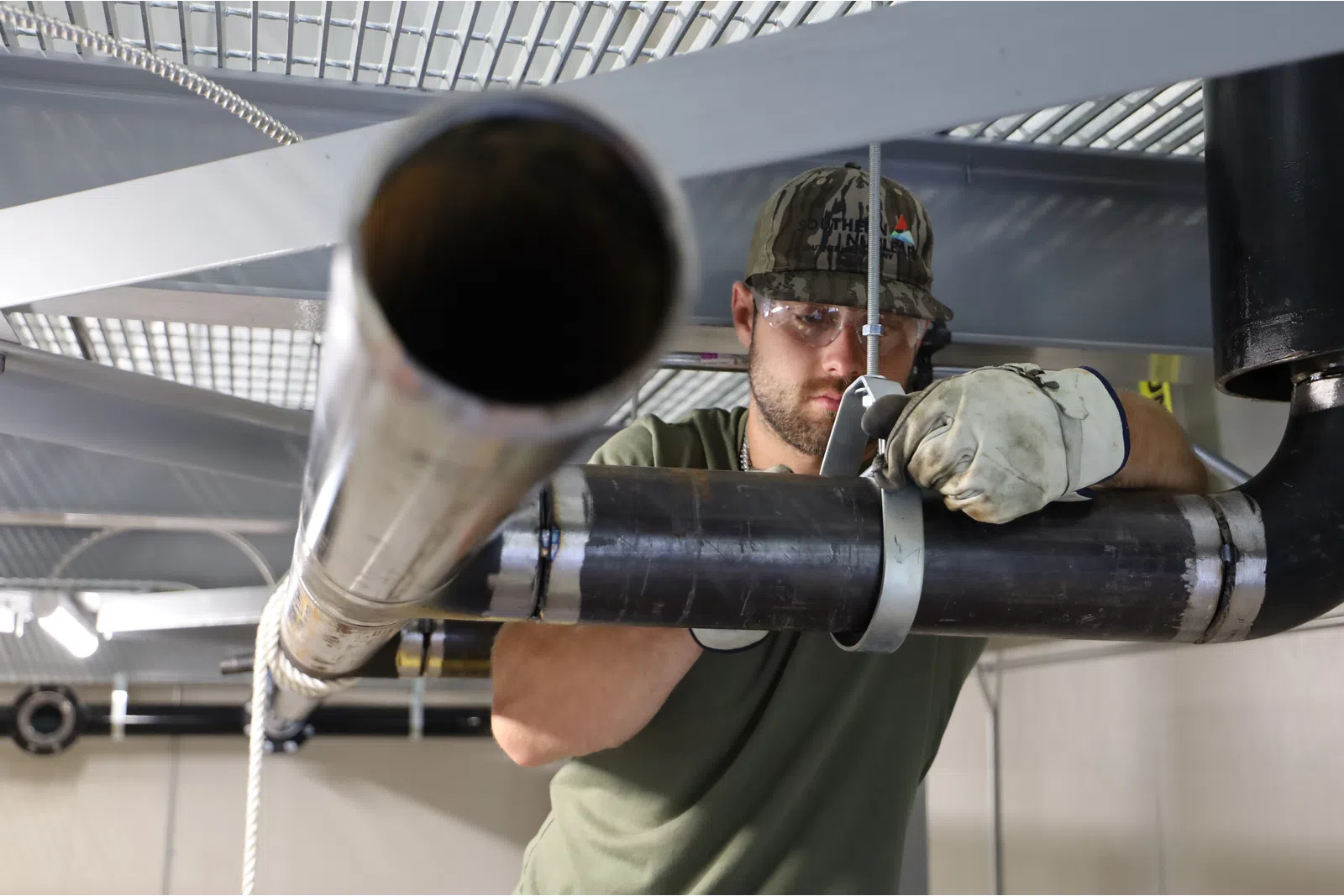 a person wearing a helmet and holding a pipe