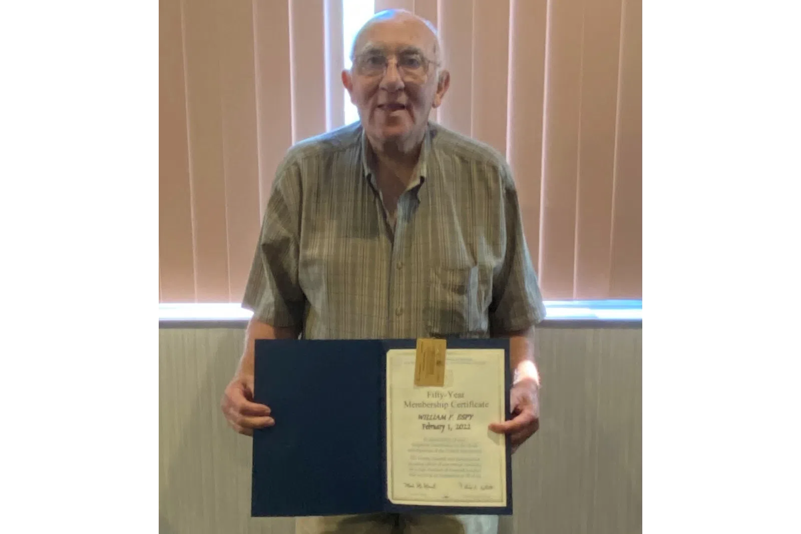 a man holding a certificate