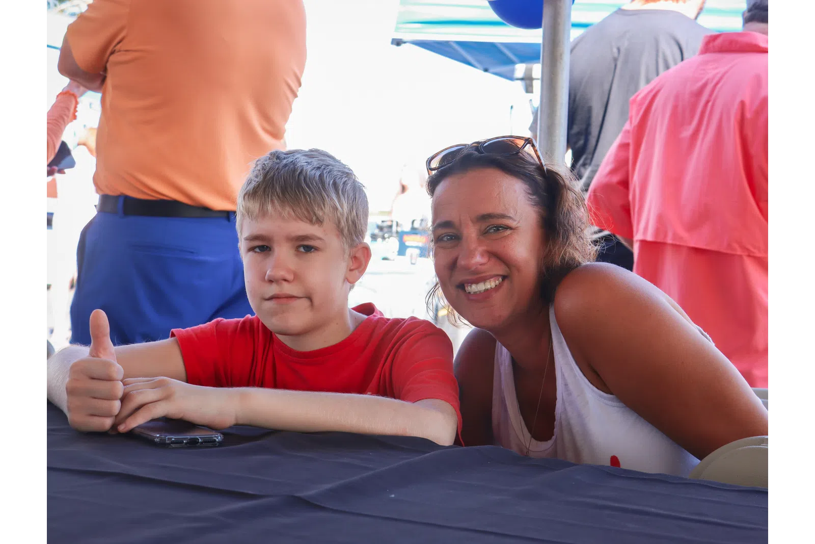 a person and a boy sitting at a table
