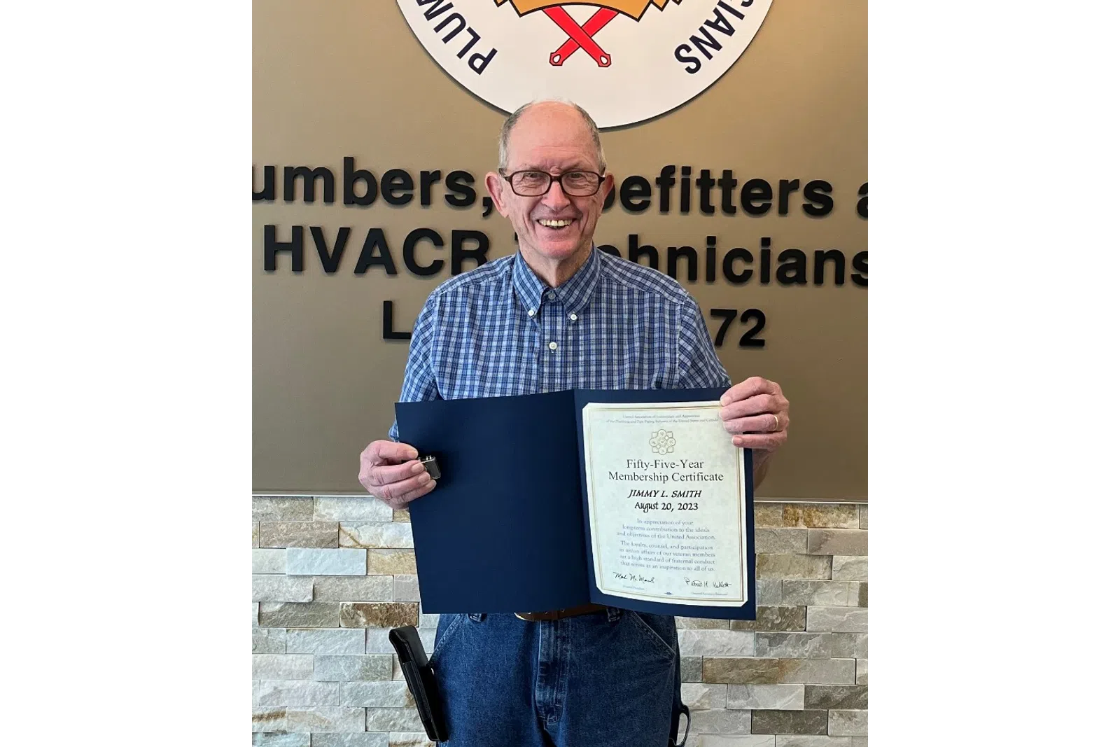 Denton Cooley holding a certificate