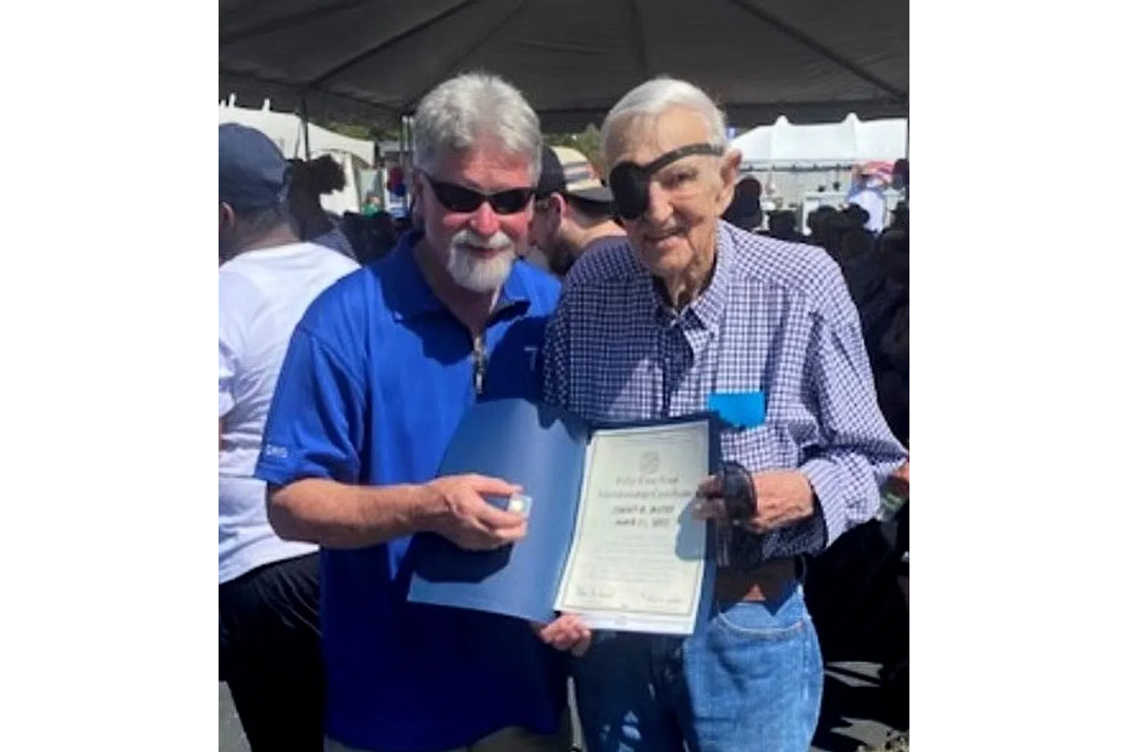 a couple of men holding a paper