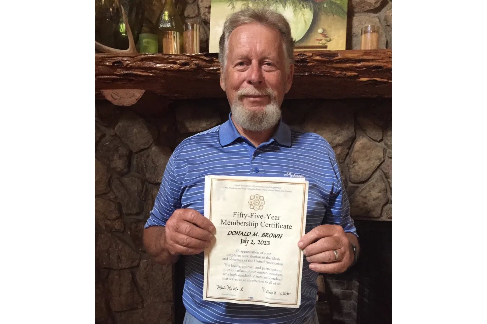 a man holding a certificate