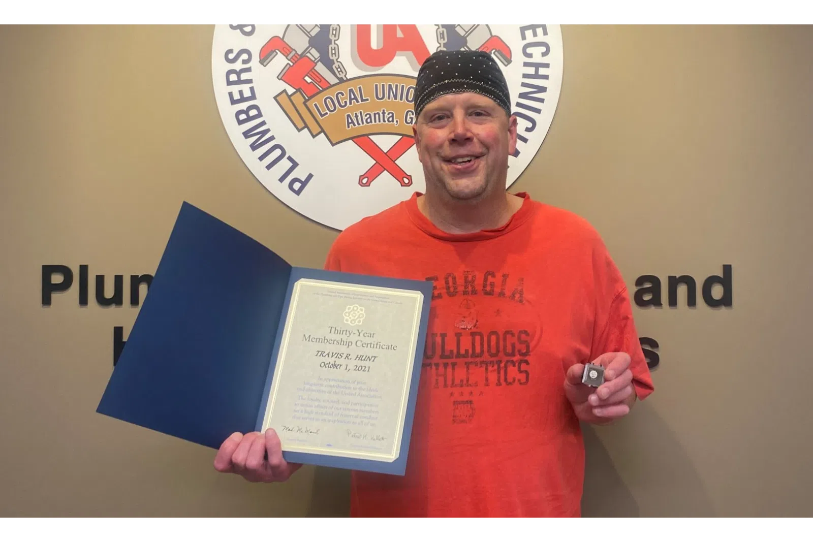 Bill Courtney holding a certificate
