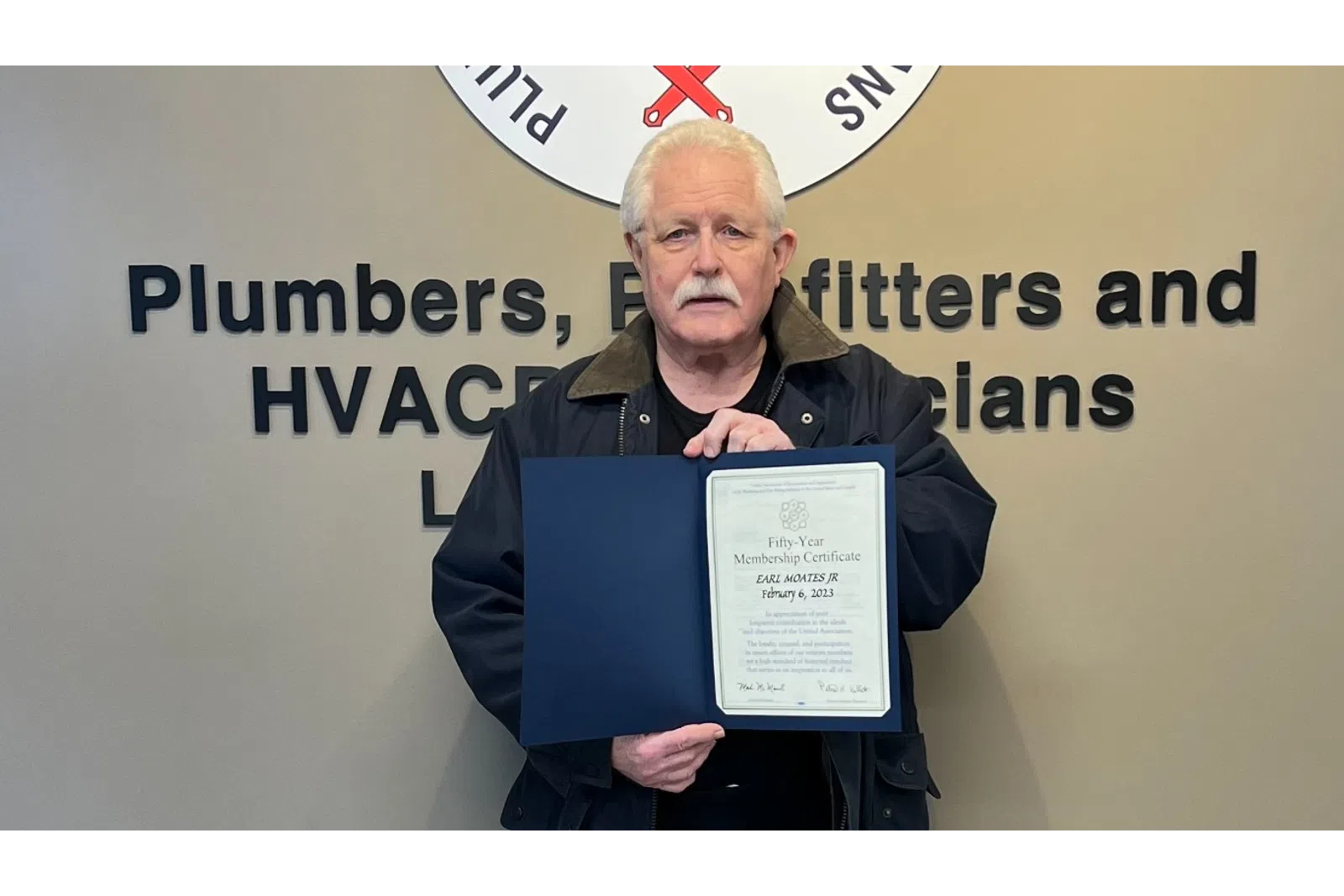 a person holding a plaque