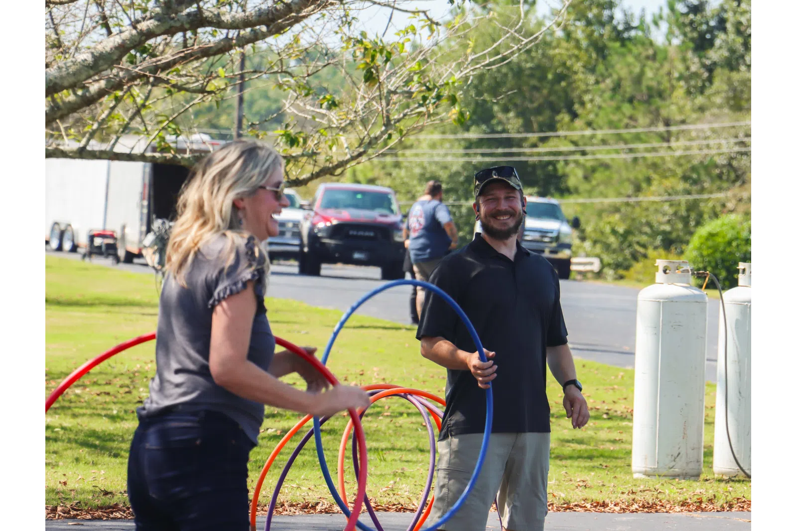 a man and woman holding a red and blue rope