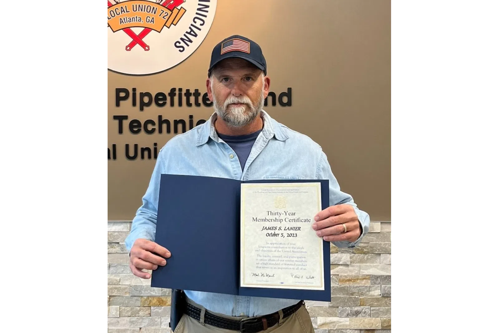a man holding a certificate