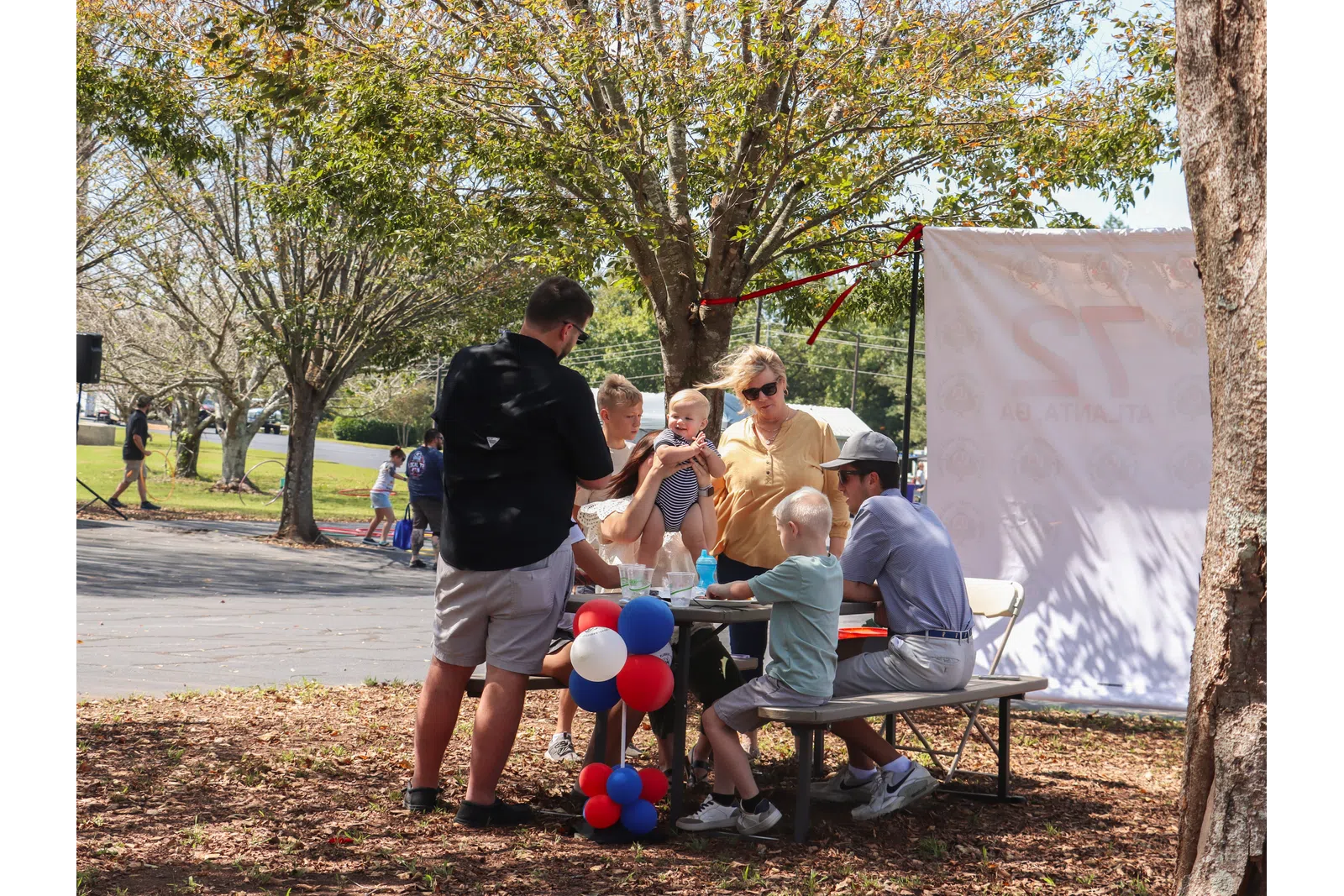 a group of people sitting at a picnic table