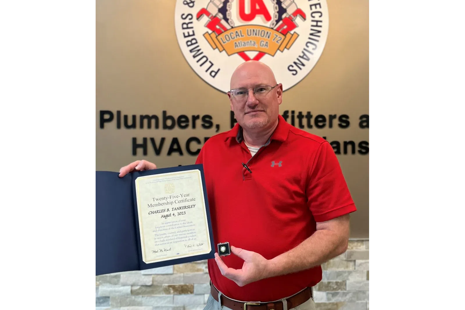 a man holding a plaque