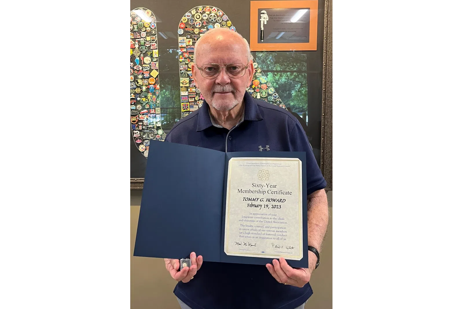a man holding a plaque