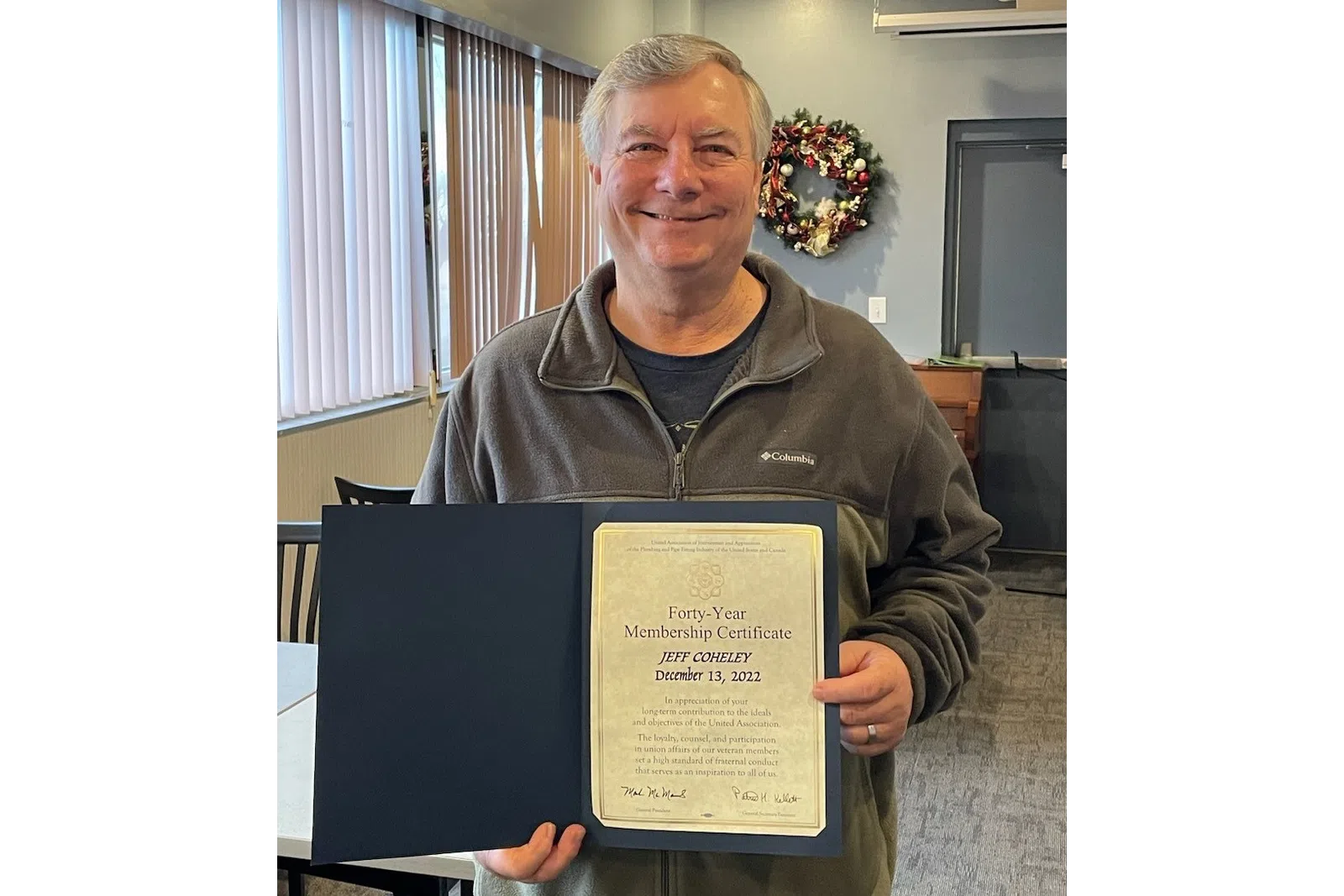 a man holding a certificate