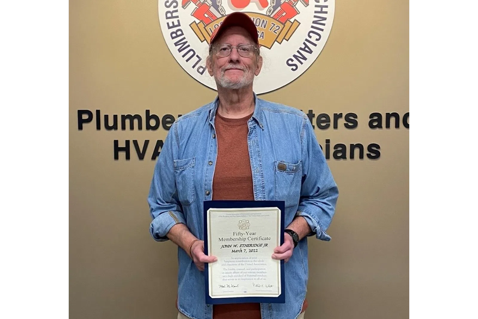 a man holding a certificate