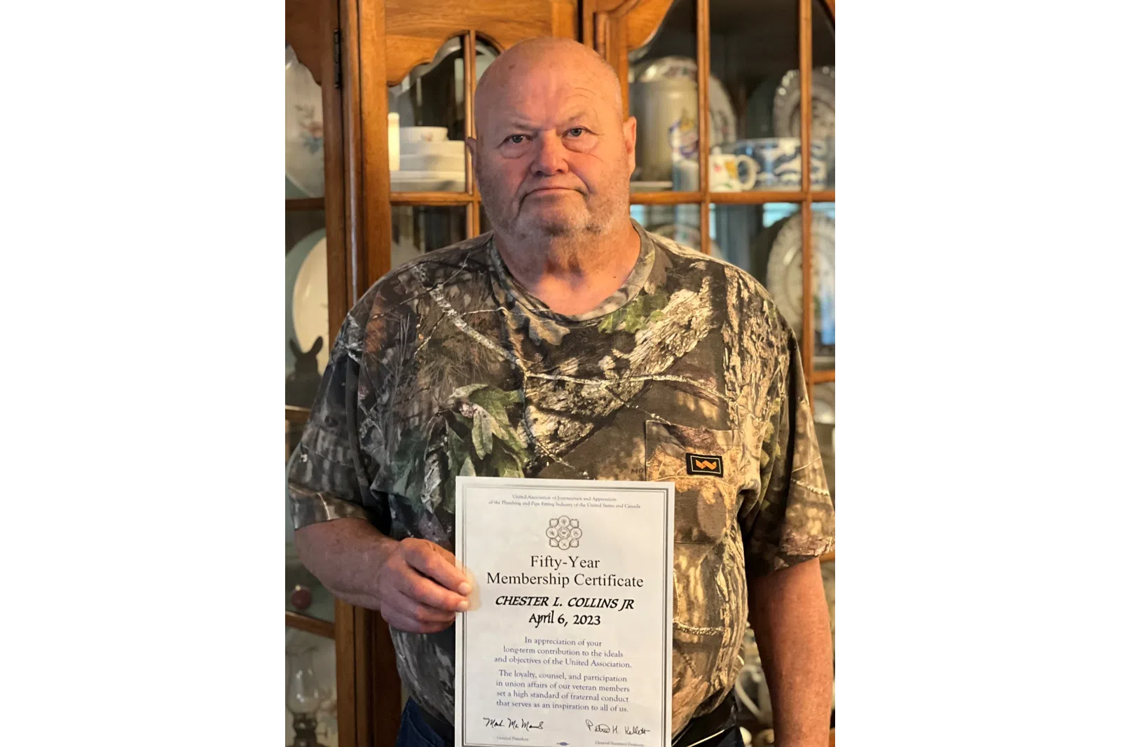 a man holding a certificate
